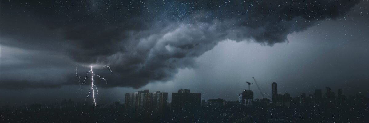 dark storm approaching city landscape - 7 Risks to Organizational Compliance Blog Featured Image